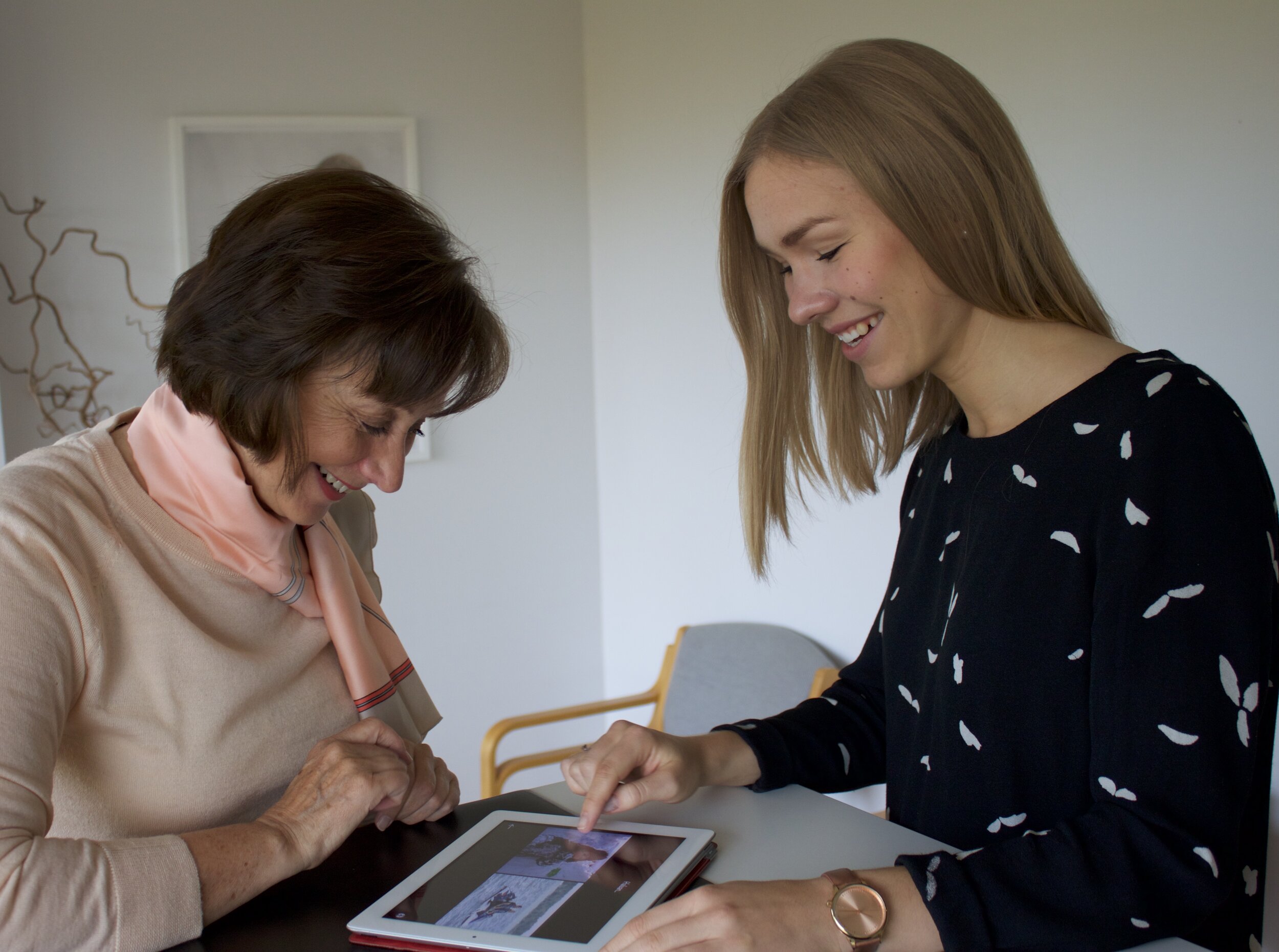 Speech-language pathologist working with a client on an iPad